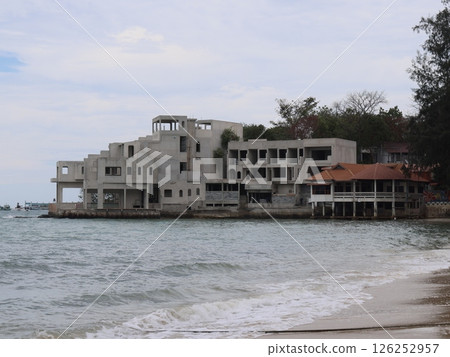 An Abandoned Coastal Structure Located Right by the Beach, Evoking a Sense of History and Isolation 126252957