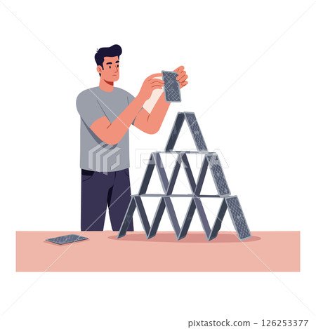 Man Building Pyramid Structure with Playing Cards on Table in Casual Setting Man Building Pyramid Structure with Playing Cards on Table in Casual Setting 126253377