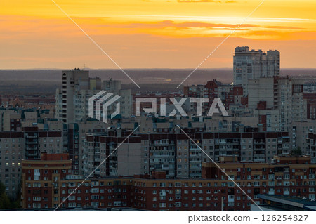 urban landscape is illuminated by the orange and pink shades of sunset. urban landscape is illuminated by the orange and pink shades of sunset. 126254827