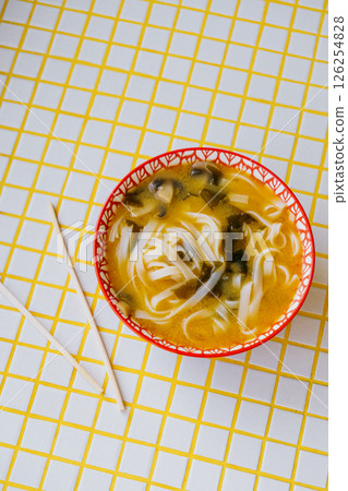 plate of noodles and chopsticks. vegetable ramen in a bright blue plate. Asian dishes. plate of noodles and chopsticks. vegetable ramen in a bright blue plate. Asian dishes. 126254828