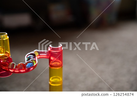 Selective focus on a toy marble run maze of multi-colored tunnels and turns  Selective focus on a toy marble run maze of multi-colored tunnels and turns  126254874
