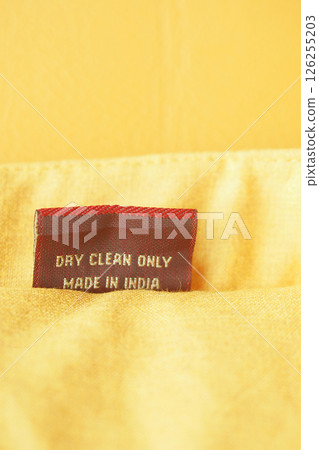 Fabric tag displaying care instructions and country of origin 126255203