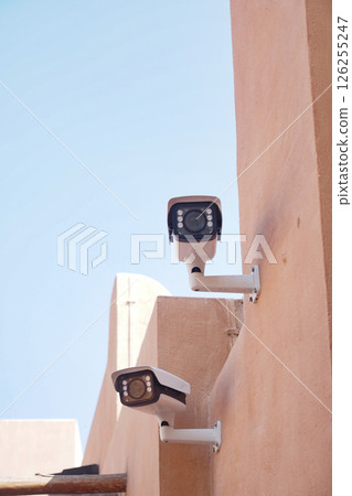Surveillance cameras mounted on a building in bright daylight 126255247