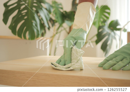 Cleaning a wooden surface in a bright indoor area 126255527