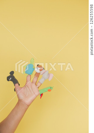 Colorful finger puppets on a bright yellow background 126255598