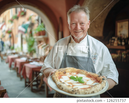 Smiling senior male chef and delicious Neapolitan pizza. Italian restaurant 126255737
