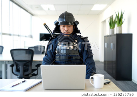 Samurai Warrior in Modern Office Working on Laptop During Daytime 126255786