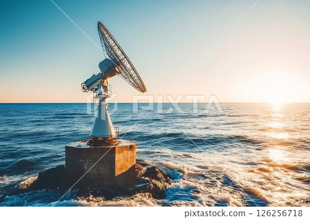 Morning Light Over Ocean with Satellite Dish and Flare in the Sky 126256718