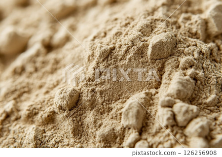 A pile of sand with a few rocks in it 126256908