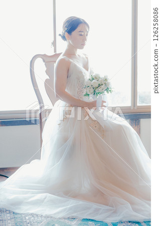 A woman in a wedding dress | A scene from getting ready for marriage 126258086