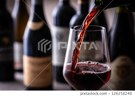 Pouring red wine into a wine glass 126258240