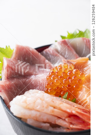 Bowl of rice topped with sashimi  126259484