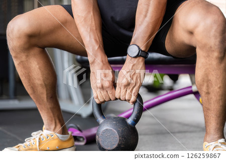 Fitness Training with Kettlebell. Athlete preparing for workout in gym. 126259867