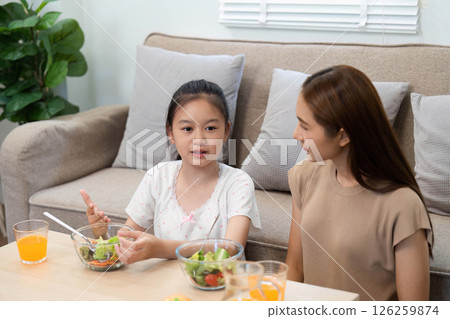Wellness: Daughter sharing ideas with mother during healthy meal Wellness: Daughter sharing ideas with mother during healthy meal 126259874