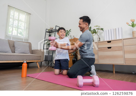 Family bonding during fitness activities with father and son 126259876