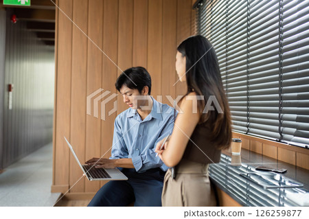 Business Collaboration and Digital Interaction. Professionals working together in a modern office environment. 126259877