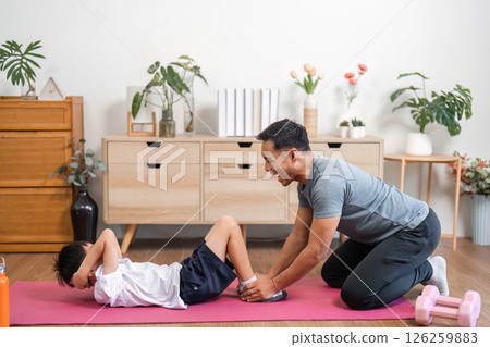 Family workout joy with father and son having fun at home Family workout joy with father and son having fun at home 126259883