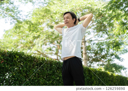 Wellness and Relaxation. Senior man stretching and enjoying nature. 126259898