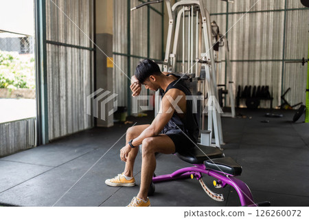 Fitness: Resting After Workout in Gym moment to rest, reflecting on his workout Fitness: Resting After Workout in Gym moment to rest, reflecting on his workout 126260072