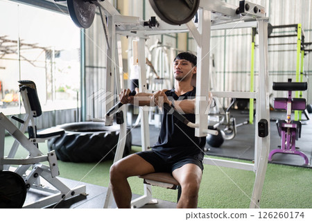 Fitness Training: Young Man Engaging in Strength Workout at Gym Fitness Training: Young Man Engaging in Strength Workout at Gym 126260174