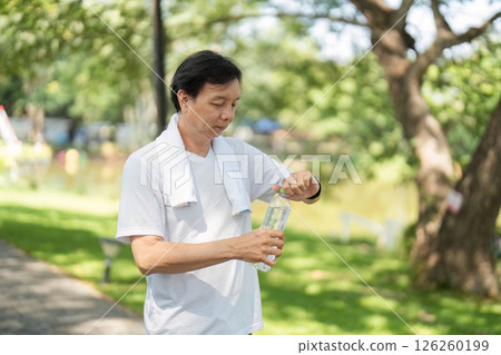 Wellness and Hydration. Man preparing to drink water after exercise. Wellness and Hydration. Man preparing to drink water after exercise. 126260199