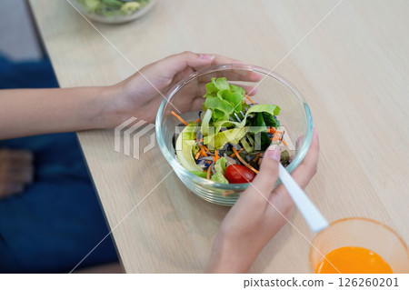 Wellness focus: hands holding a fresh salad bowl 126260201