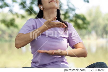 Wellness and Mindfulness. Woman engaged in mindful movement outdoors. 126260289