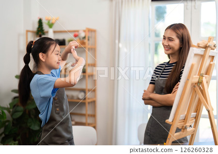 Family time: Mother and daughter sharing creativity while painting 126260328