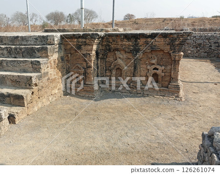 The remains of a pagoda with a double-headed eagle sculpture remaining at the Sirkap ruins, an ancient city ruin from around the time of Christ in Taxila, Pakistan 126261074
