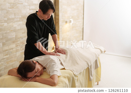 Relaxation staff and senior female customer 126261110