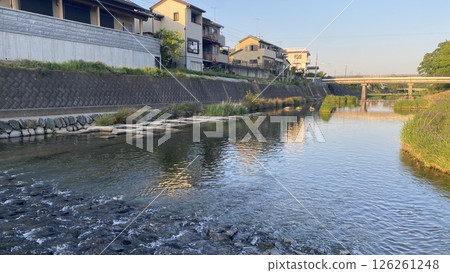 River flowing through a rural town 126261248
