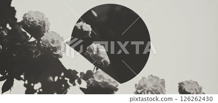 Minimalist design featuring a compact mirror and floral elements arranged on a white backdrop. 126262430