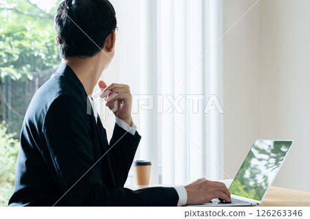 A man working on a laptop computer A man working on a laptop computer 126263346