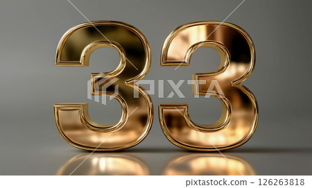 Golden number 33 displayed on a reflective surface with a neutral background 126263818