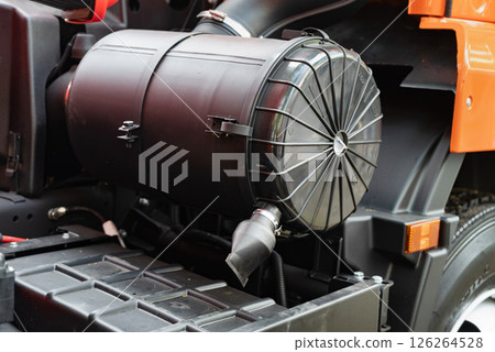 Close-up of a truck air filter housing and exhaust pipe on industrial machine. Close-up of a truck air filter housing and exhaust pipe on industrial machine. 126264528