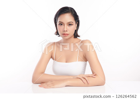 A beautiful young Asian woman with clean, fresh skin against a white background. Skincare, facial treatment, cosmetology, beauty, and spa. An elegant portrait of an Asian woman. 126264562