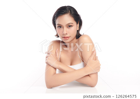 A beautiful young Asian woman with clean, fresh skin against a white background. Skincare, facial treatment, cosmetology, beauty, and spa. An elegant portrait of an Asian woman. 126264575