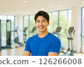 A handsome man smiling at the gym. A realistic illustration of a slim and muscular Japanese man. 126266008