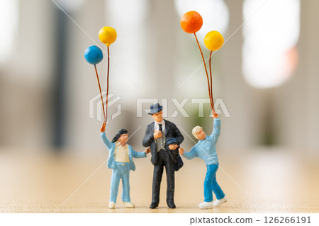 Miniature figurines of a father with happy children holding balloons Celebration on Father Day Miniature figurines of a father with happy children holding balloons Celebration on Father Day 126266191