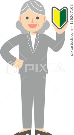 A woman in a suit holding a beginner's mark 126267108