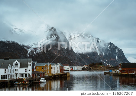 Fishing village of Henningsvaer with snowy mountain backdrop 126267267