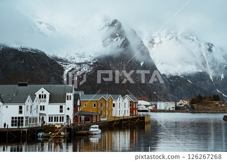 Fishing village of Henningsvaer with snowy mountain backdrop 126267268