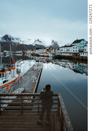 Fishing village of Henningsvaer with snowy mountain backdrop Fishing village of Henningsvaer with snowy mountain backdrop 126267271