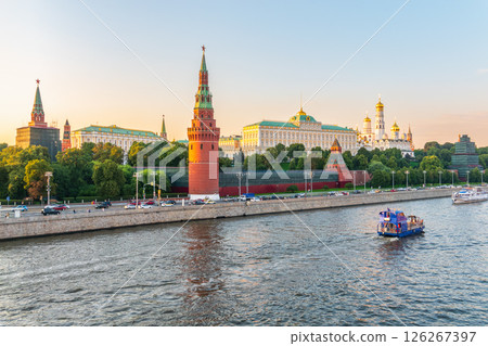 View of Kremlin with Vodovzvodnaya tower, Grand Kremlin Palace from repaired Bolshoy Kamenny Bridge in Moscow city on sunny summer day. Cruise ship sails on the Moscow river View of Kremlin with Vodovzvodnaya tower, Grand Kremlin Palace from repaired Bolshoy Kamenny Bridge in Moscow city on sunny summer day. Cruise ship sails on the Moscow river 126267397