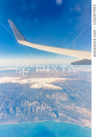 View from the airplane window of the mountains and sea resort with corals in Egypt, Sharm El Sheikh.Flight 126267403