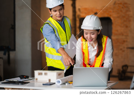 Construction engineers discussion with architects at construction site or building site 126267863