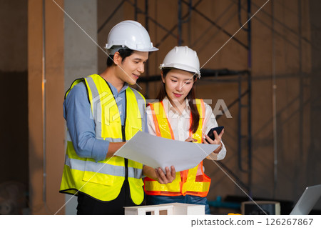Construction engineers discussion with architects at construction site or building site 126267867