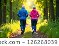 Gray-haired grandparents in tracksuits jogging in the park, view from the back 126268039
