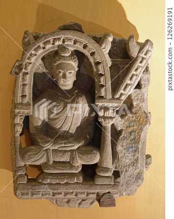 A meditating Buddha statue at the Peshawar Museum in Gandhara, Pakistan, an important figure in the history of Buddhist sculpture 126269191