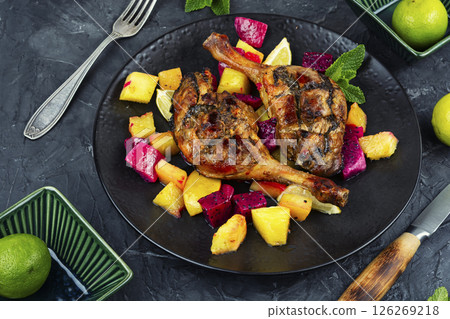 Served with tropical fruits, roast duck leg. 126269218